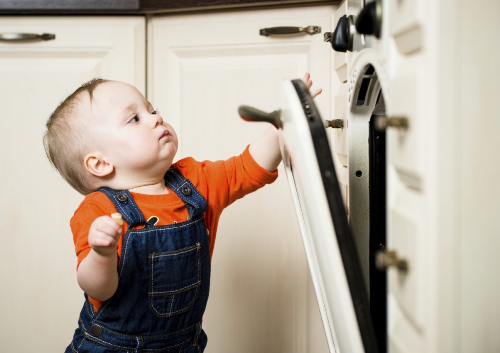Baby watching inside kitchen oven