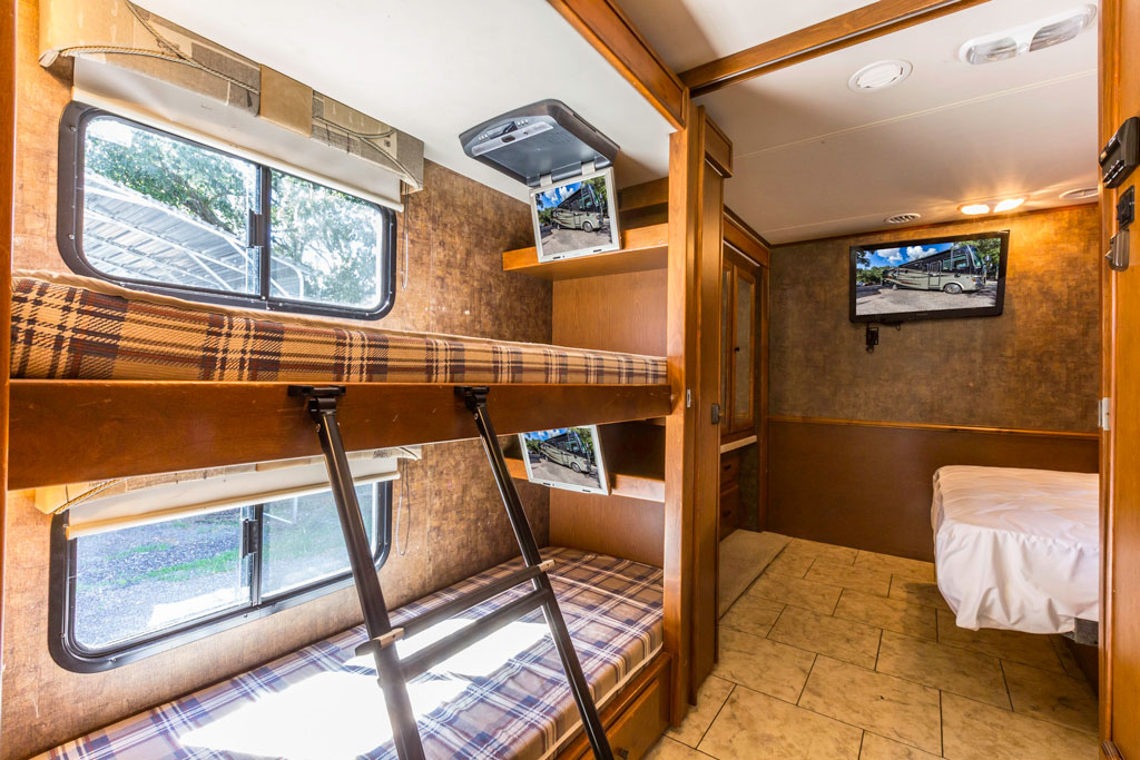 travel trailer with bunks behind couch