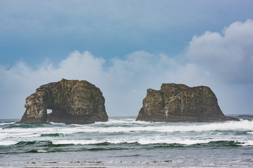 Twin Rocks in Rockaway Beach, Oregon during overcast, misty weather
