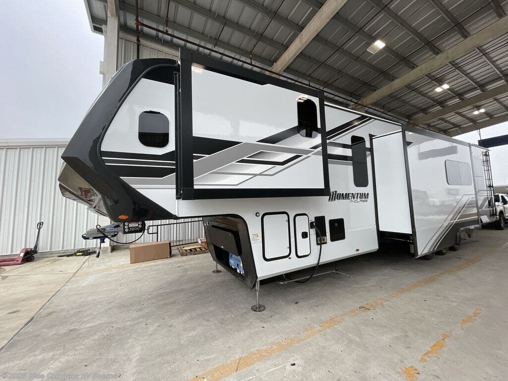 exterior of a 2025 Grand Design Momentum M-Class 395MS fifth wheel toy hauler rv