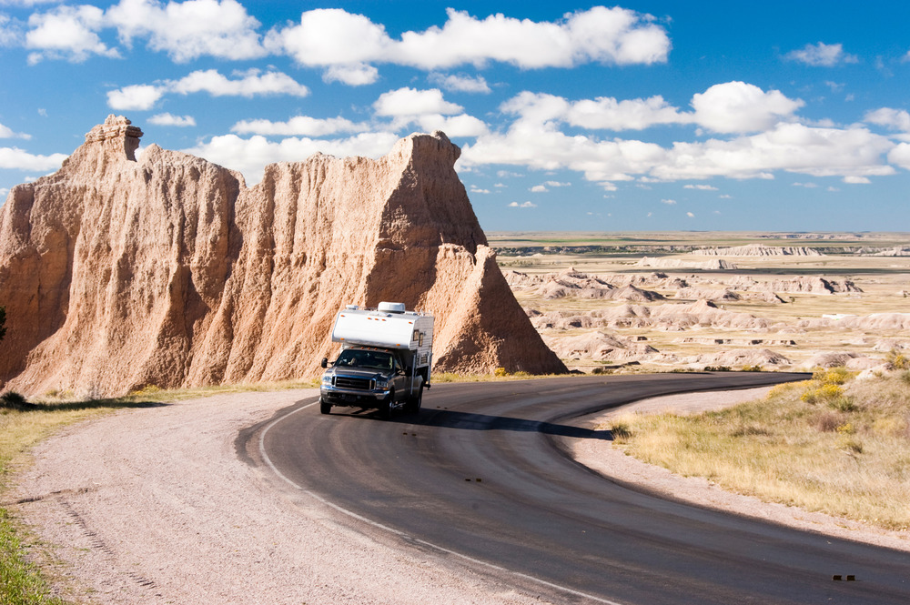 truck camper traveling down the road