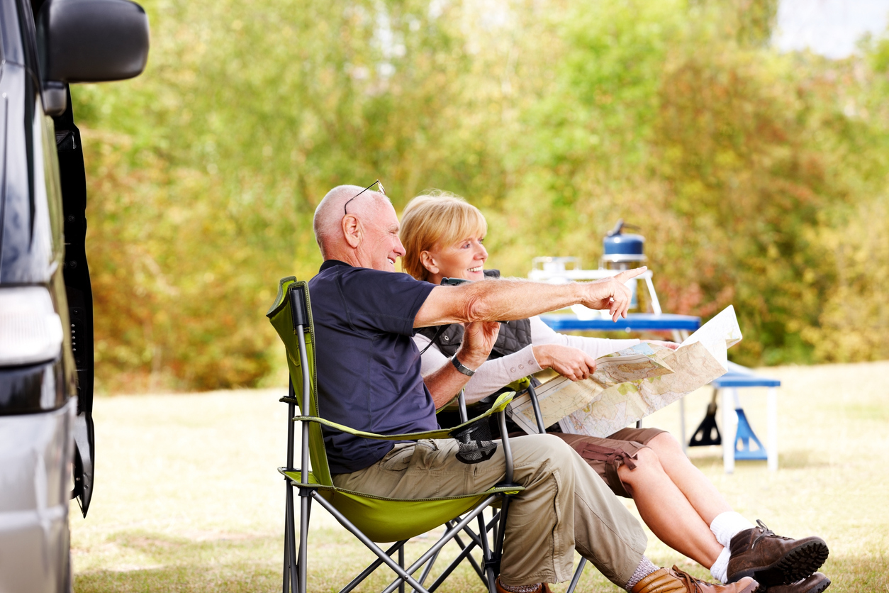 A man and a woman enjoy time outside their RV. We debunk RV myths about the stereotypes of RVing.