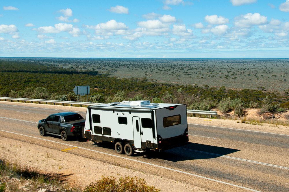 truck towing a travel trailer on the road