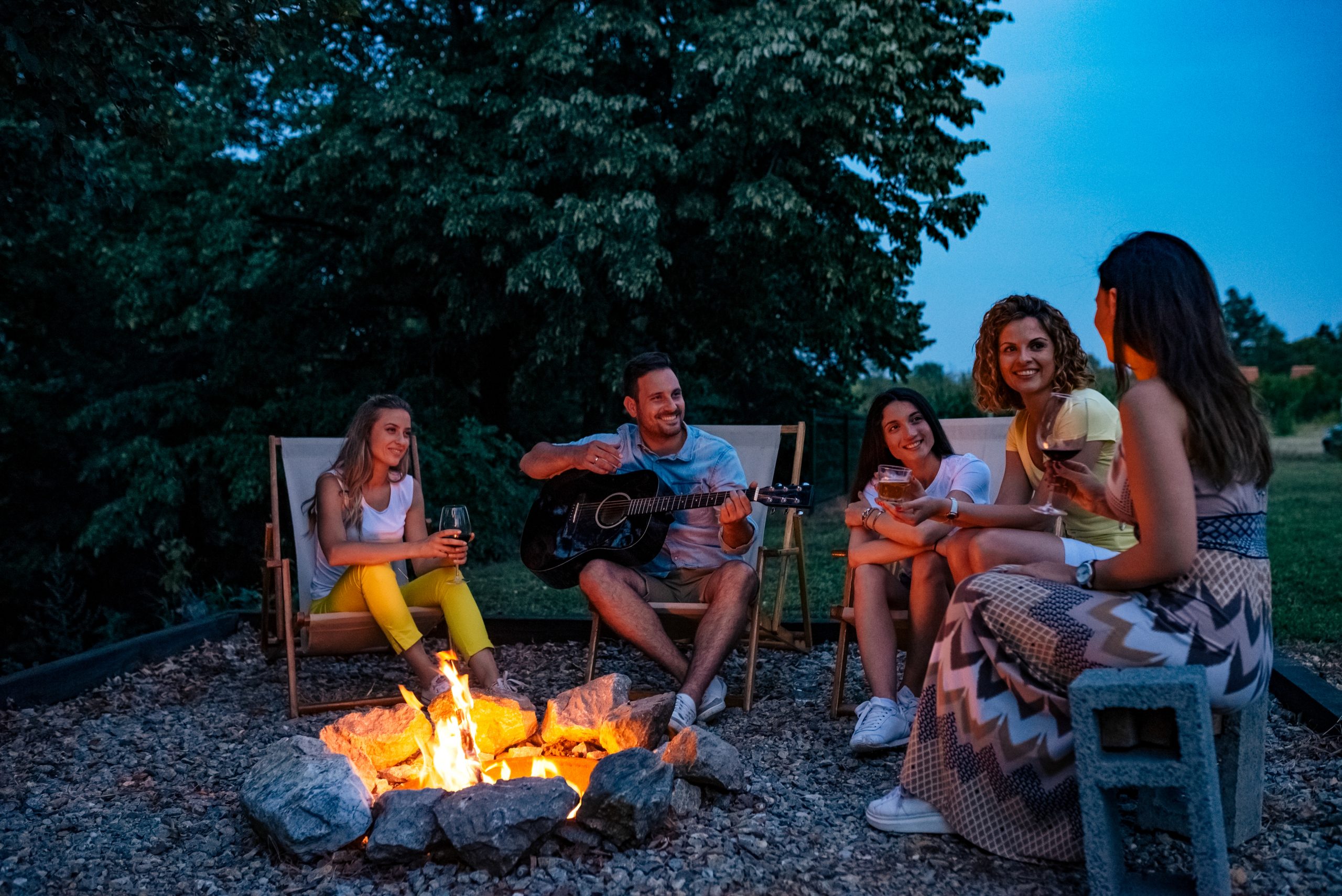 tin foil pack campfire recipes - people sitting around campfire