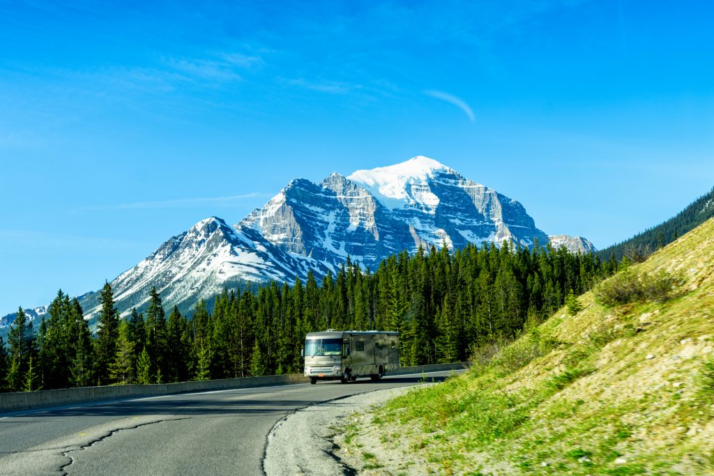 Class A RVs - motorhome driving past mountains