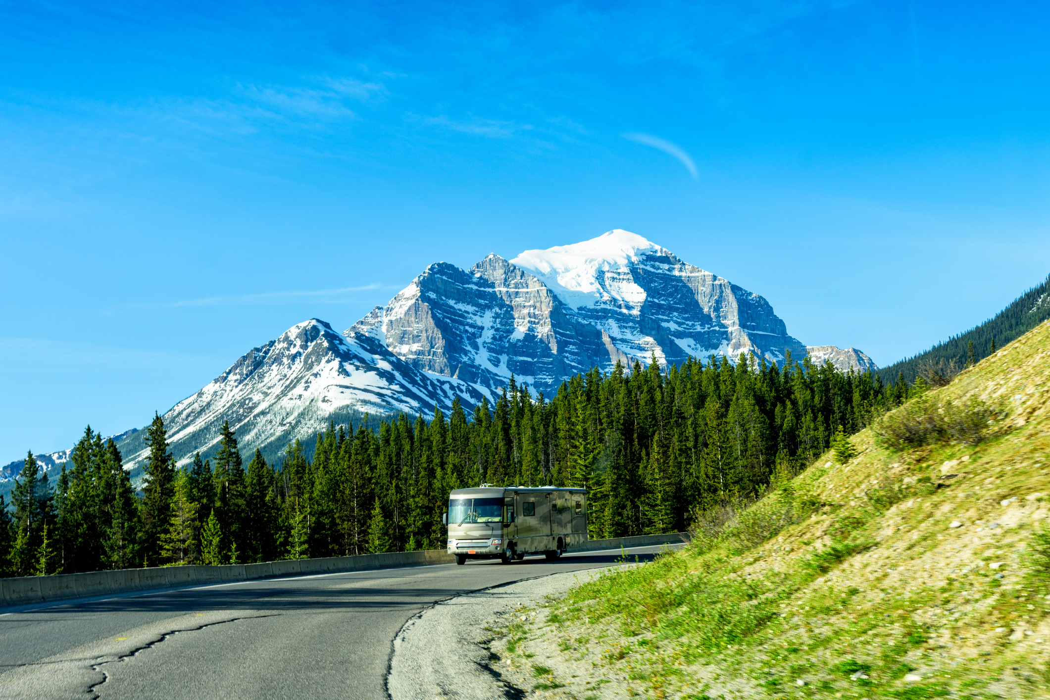 Class A RVs - motorhome driving past mountains