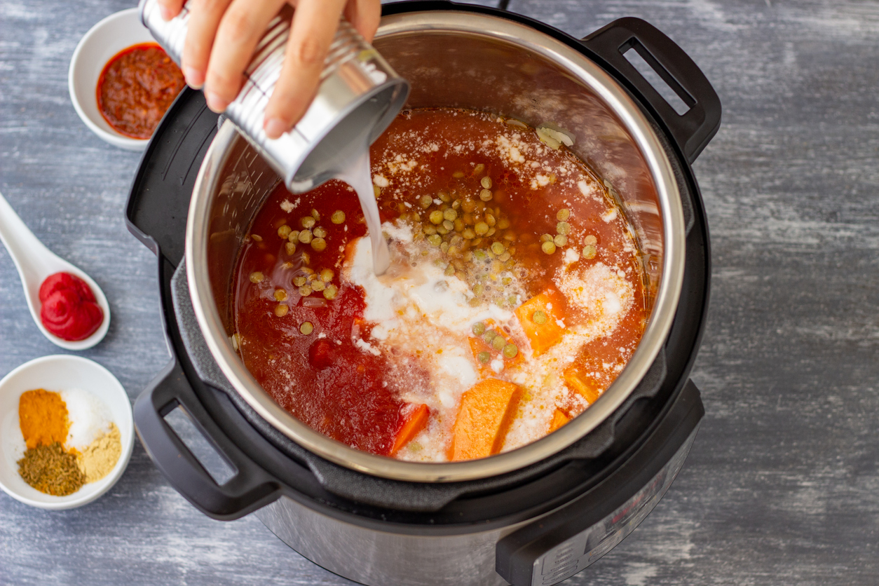 Woman pours ingredients into an Instant Pot in an RV