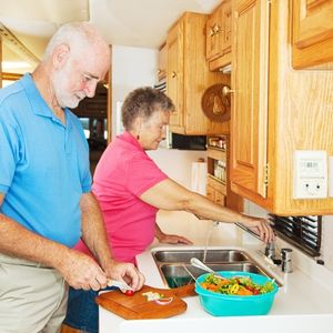Couple cooking a holiday dinner in an RV kitchen Older couple cooking their holiday dinner in their RV kitchen with RV kitchen essentials