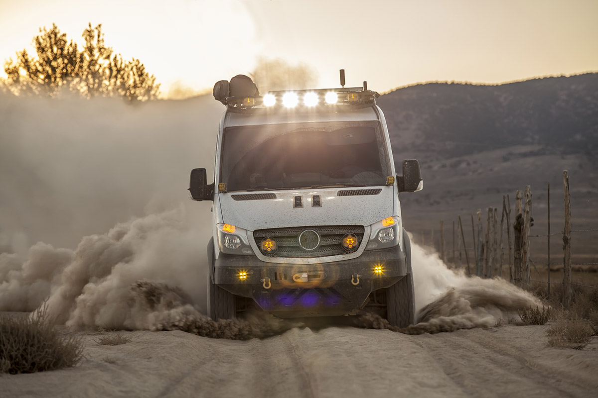 An overland camper van drives on a dirt road to announce the new overland classifieds on RVUSA