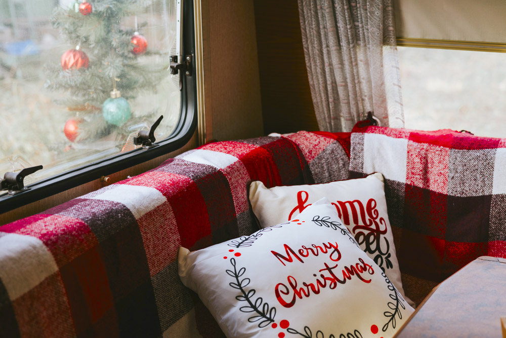 A set of Christmas pillows and a blanket in an article about last minute RV Gifts