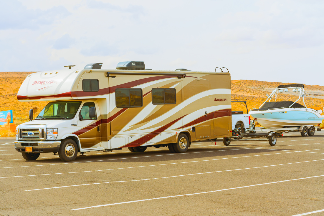 Lake Powell, Utah - RV towing a boat. Lake Powell beach, parking lot