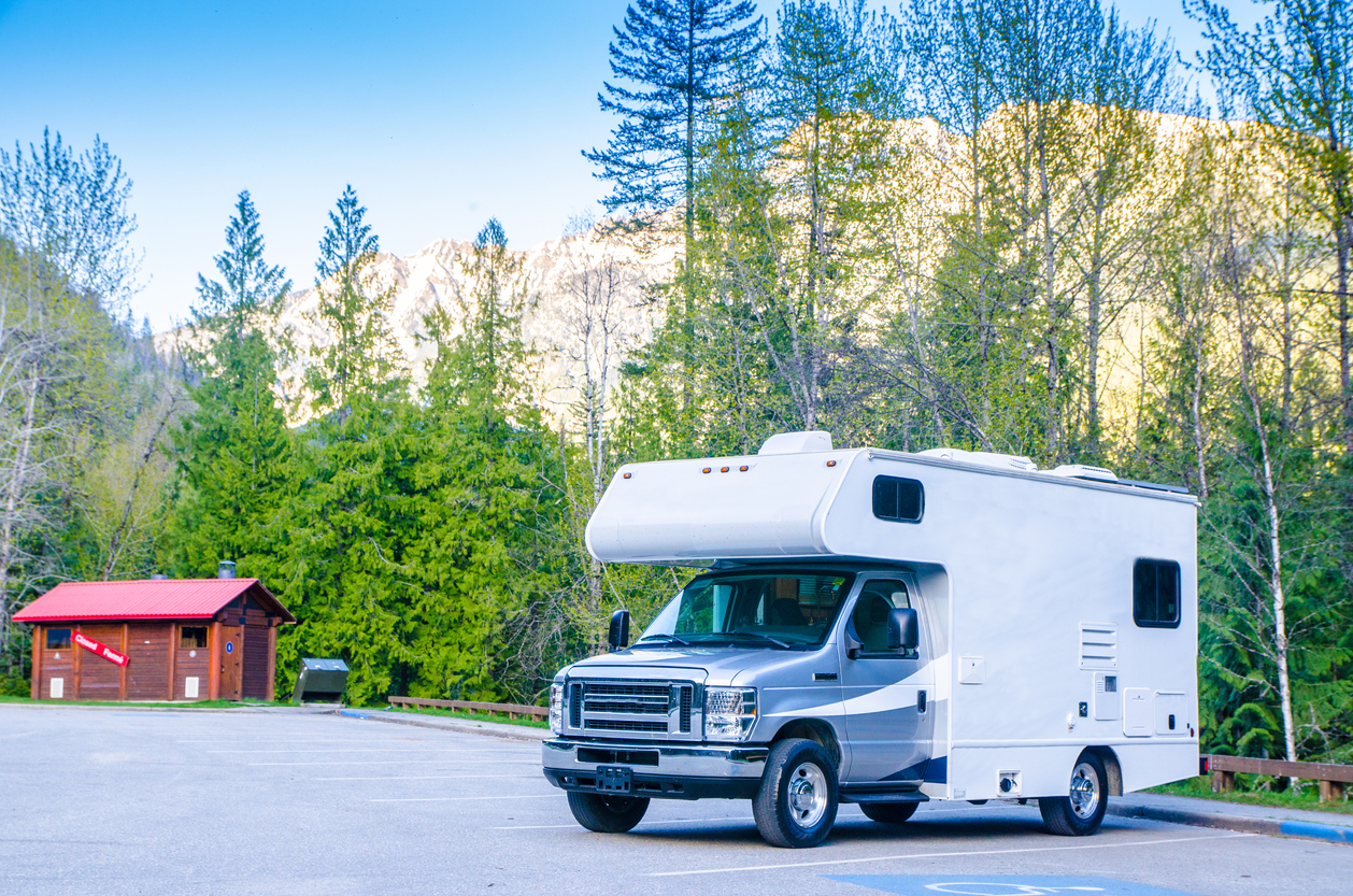 Class C parked for overnight RV parking in an empty parking lot.