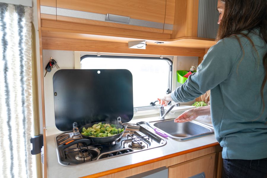 Woman cooking in a rv kitchen