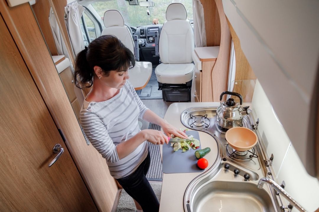 woman rv cooking for two people