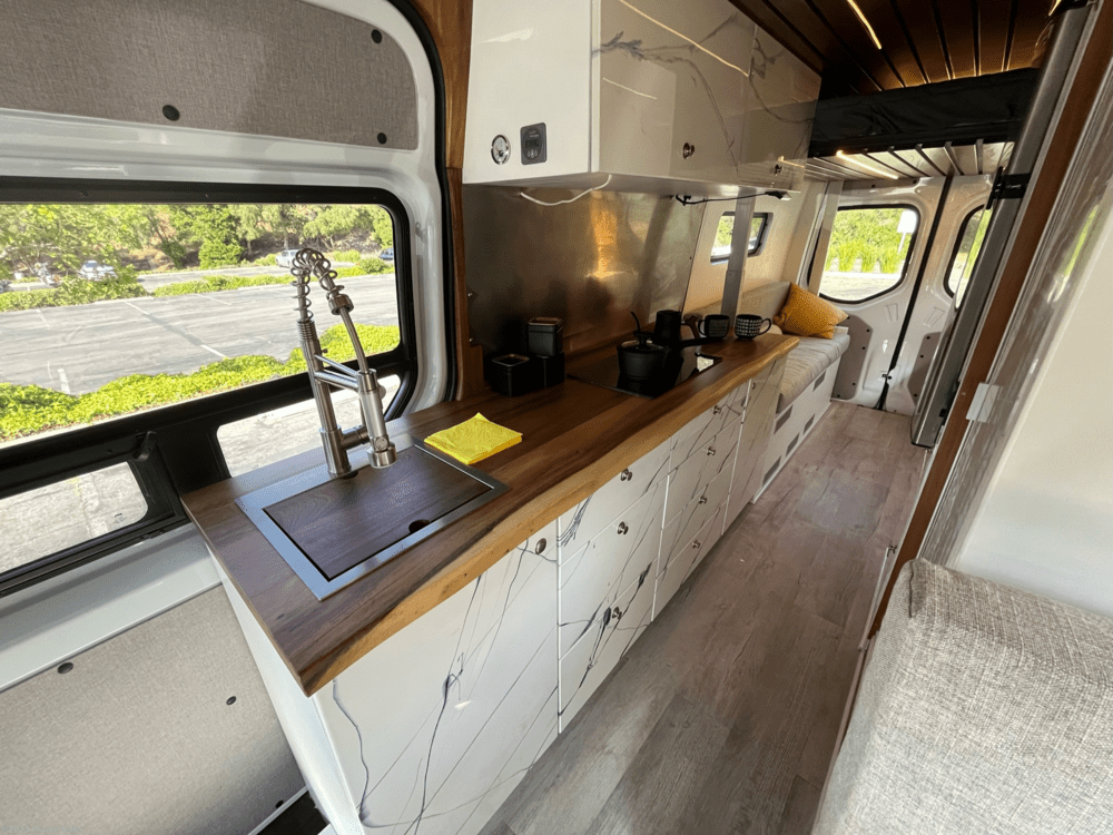 interior of 2021 Mercedes-Benz Sprinter with marble cabinets and  a powerlifting loft bed