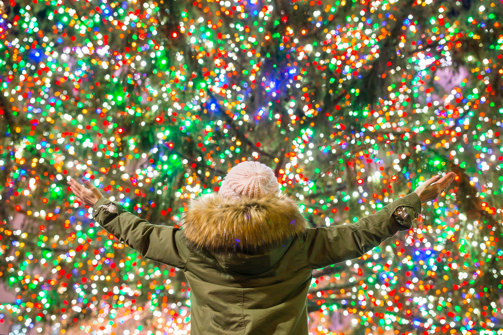 Girl happy looking upon Chritsmas tree