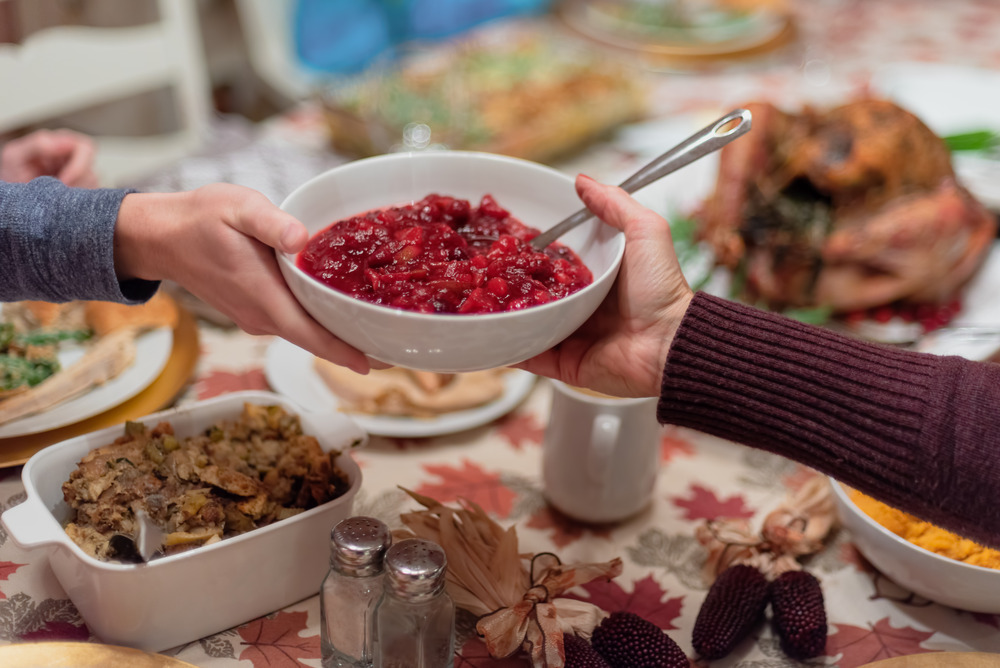Cranberry sauce being passed around at thanksgiving dinner
