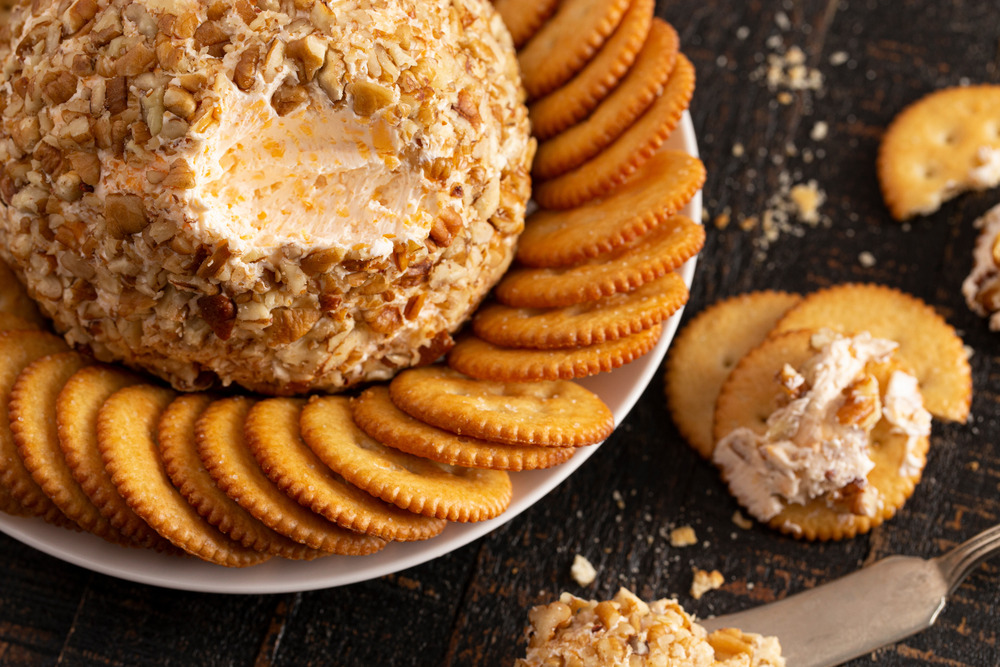 cheeseball dip with crackers on a serving dish