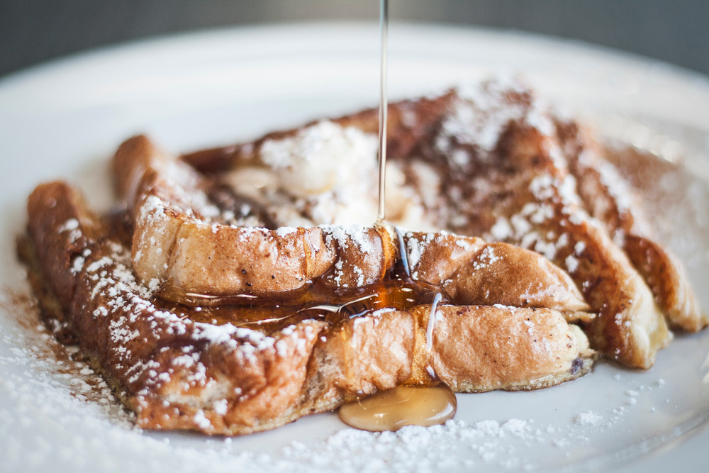 syrup being poured over french toast