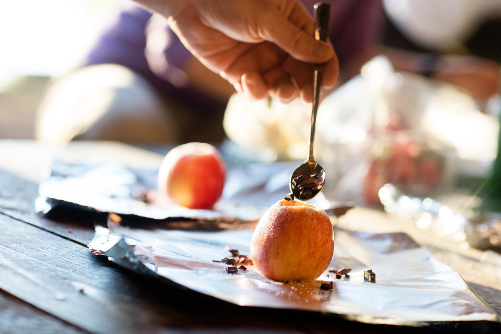 hand stuffing chocolate chips into apples