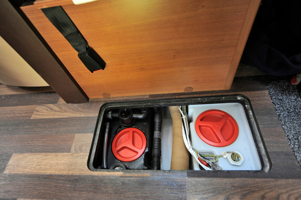 Clean and wastewater tanks inside the bottom of an RV