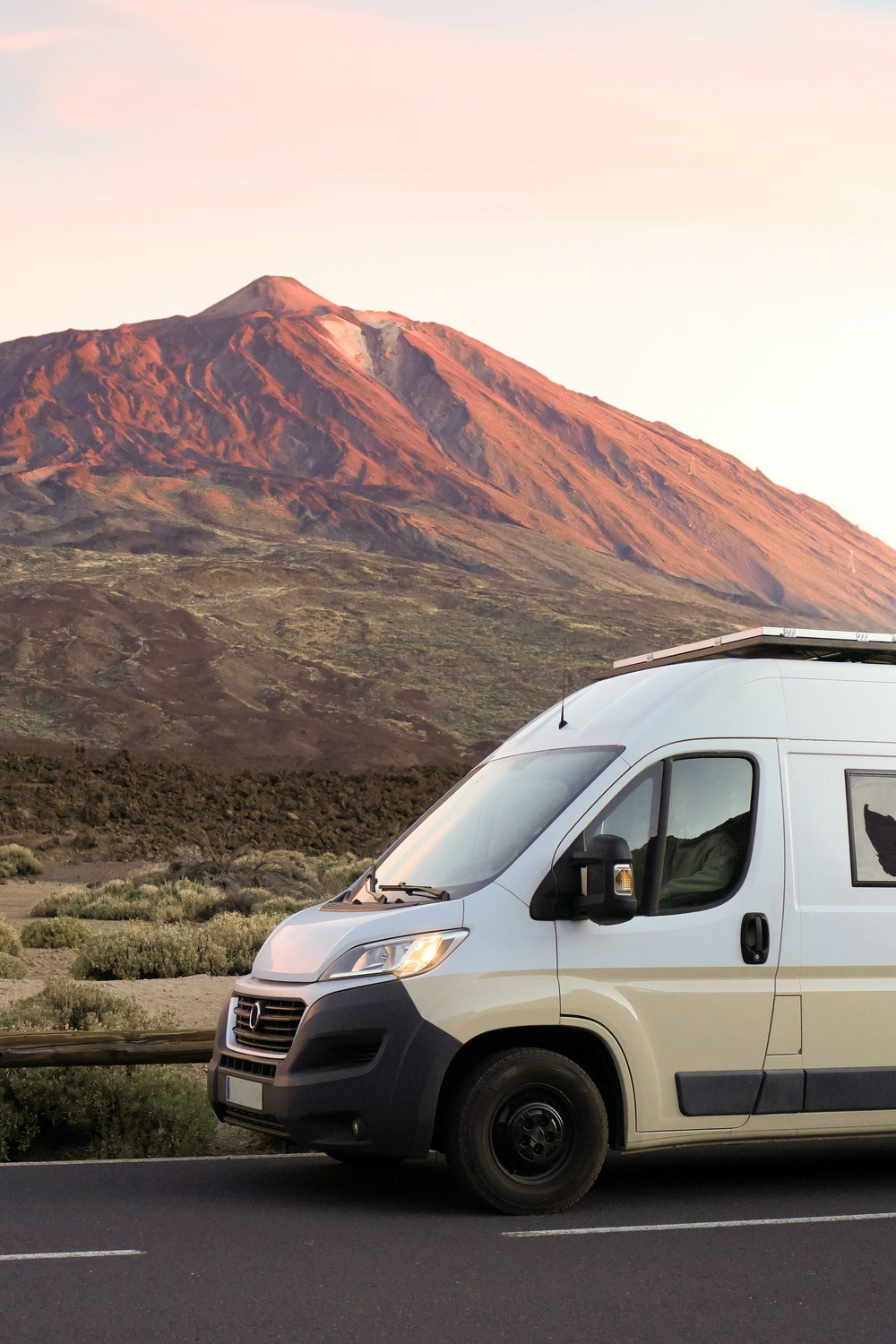 affordable rv on the road in front of a Mountain view
