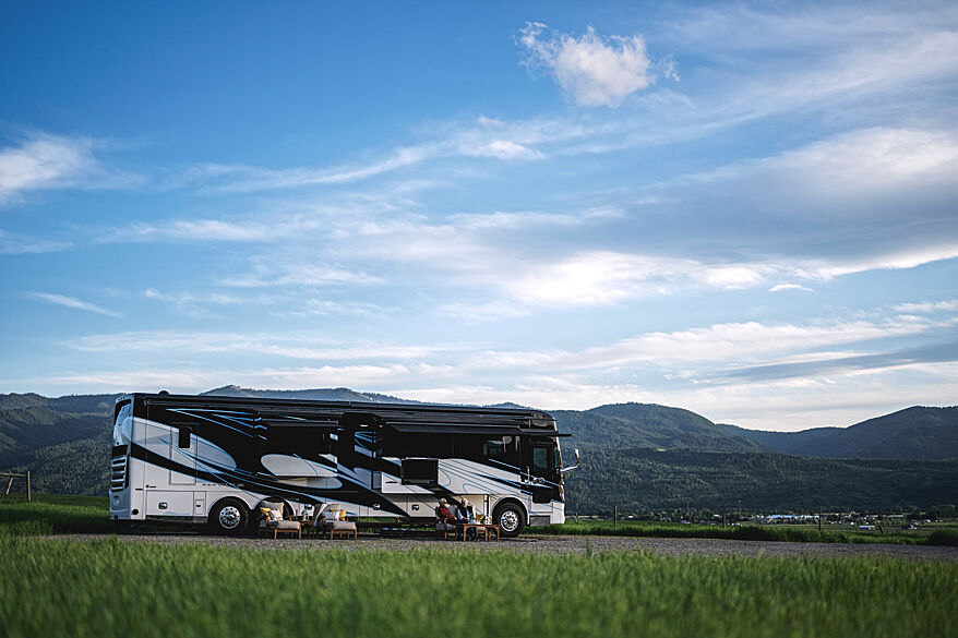 The Tiffin Zephyr, one of our best 2024 Class A motorhomes, set up at a campsite in the mountains.