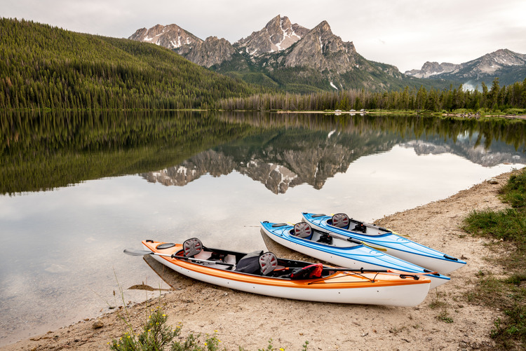 canoeing in a beautiful small town Three canoes on Stanley Lake Idaho in summer