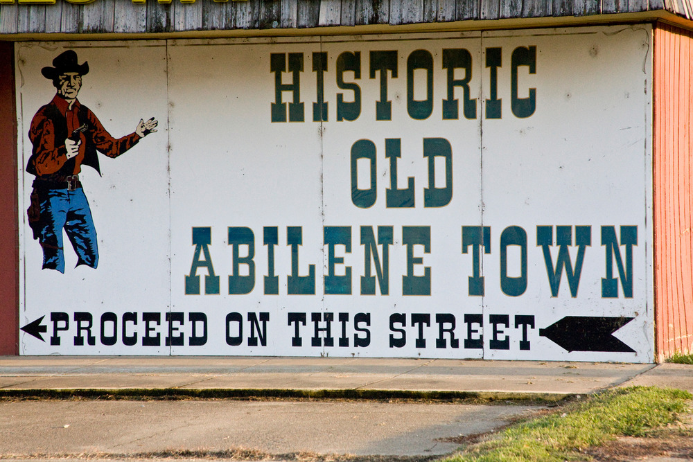 small town of historic Old Abilene A painted sign directs visitors to historic Old Abilene Town