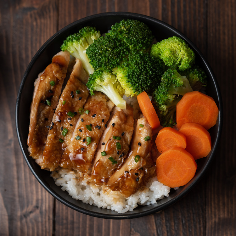 op view of Homemade Chicken Teriyaki grilled with rice , carrot , broccoli in a bowl