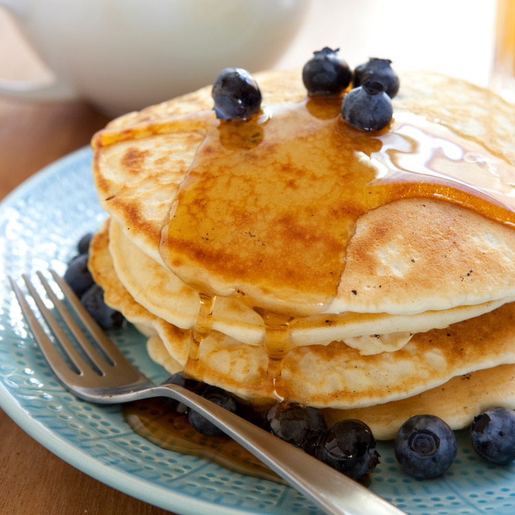 Greek yogurt pancakes topped with honey and blueberries
