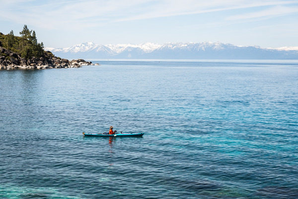 Man fishing in kayak on Lake Tahoe. 