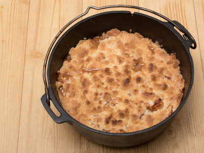 Dutch oven apple crisp cooked over campfire