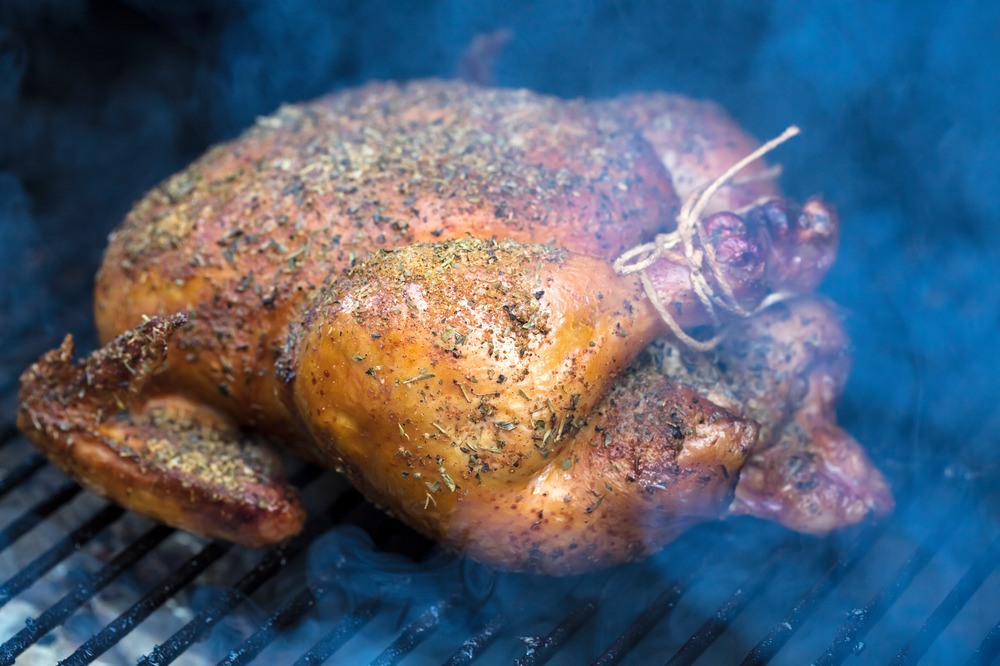 smoked thanksgiving turkey on the grill over a campfire