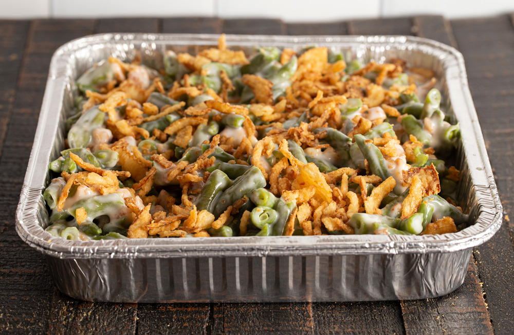 Traditional Green Bean Casserole with Fried Onions on a Wooden Table