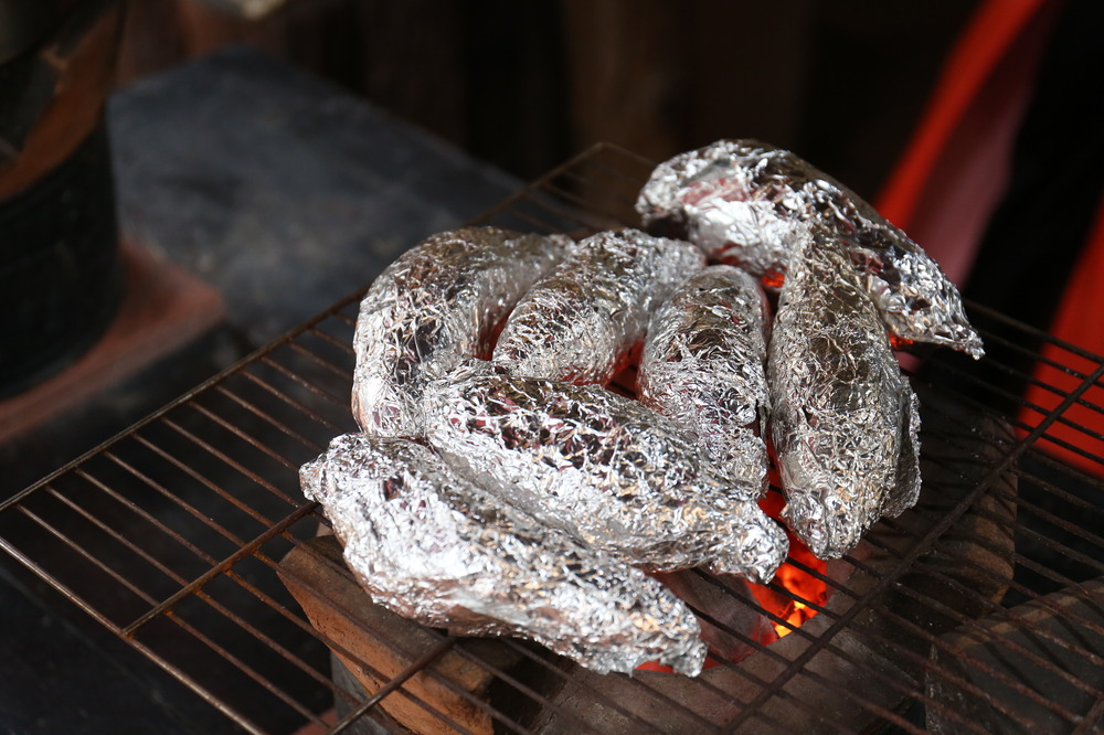 sweet Potatoes wrapped in foil over a campfire