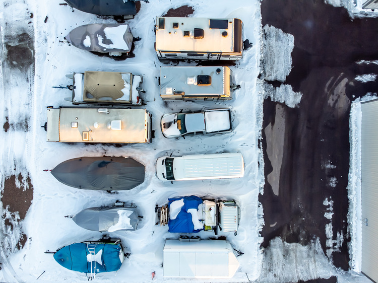 Drone view of RVs, campers, and boats in winter storage