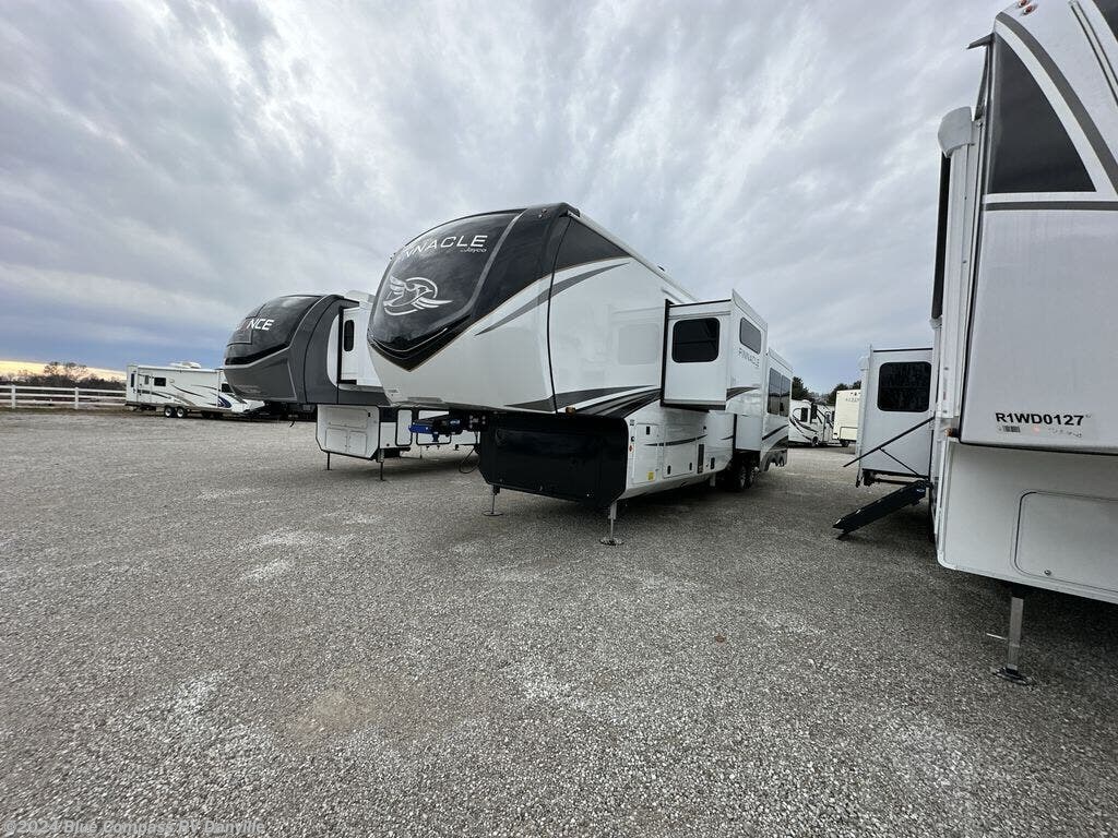 multiple fifth wheel rvs for sale at a dealership that also offers rv insurance