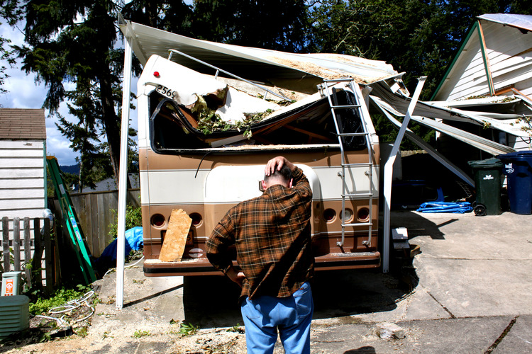 man looking at damaged rv waiting for RV insurance