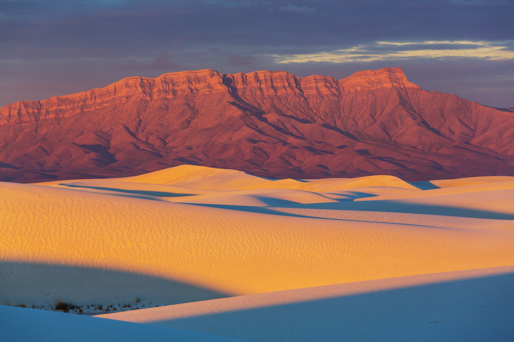 Dunes in front of mountain range at White Sands National Park in New Mexico