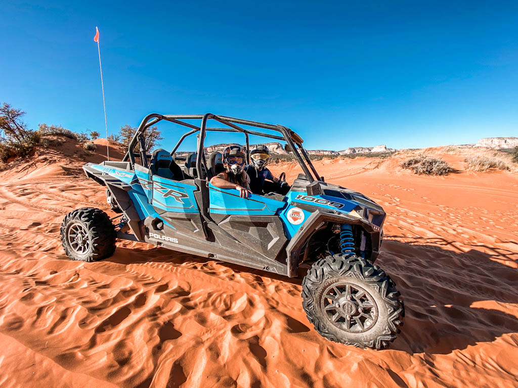 Our blog authors pose in an ATV in the Utah desert. 