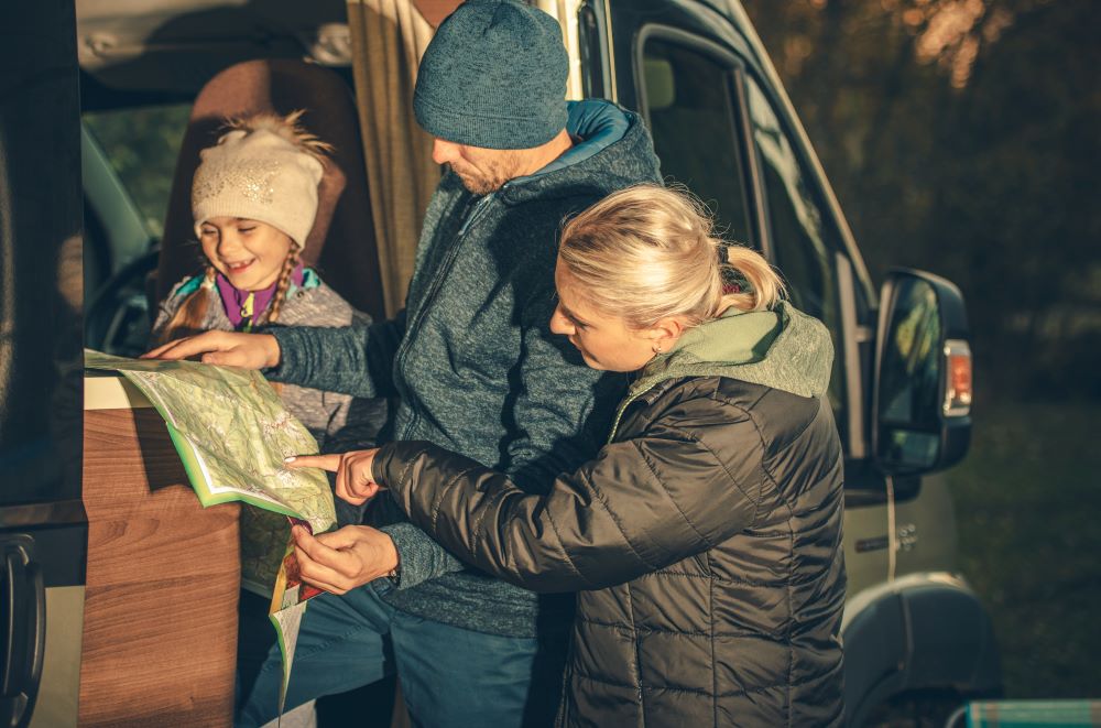 family on a RV trip Family Taking Look on the Map in the RV Motorhome Side Doors.