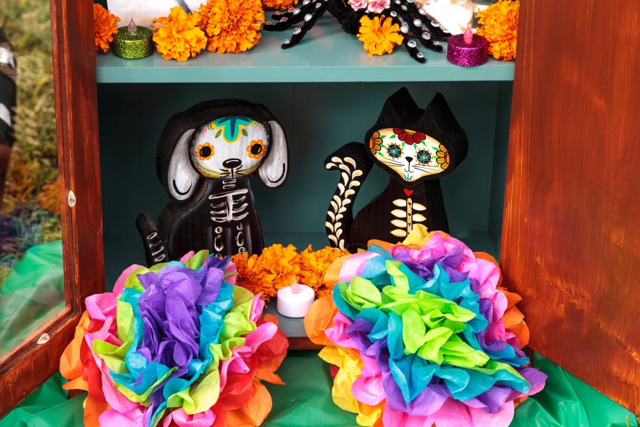mache dog and cat skeletons on a day of the dead altar