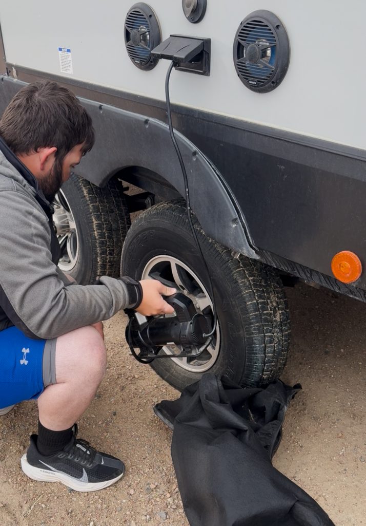 Jon fixing a tire on their RV.
