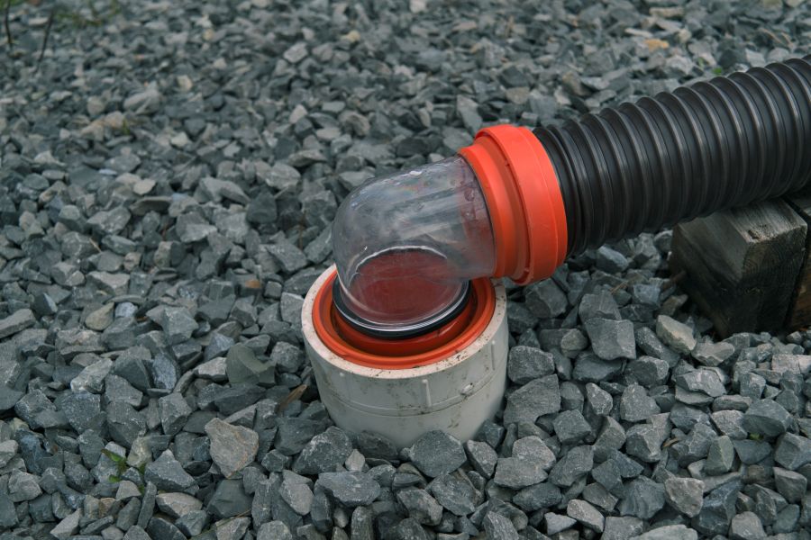 RV sewer hose connected to dump station