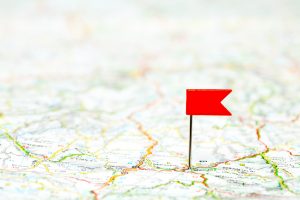 Red color flag pin on map, shallow focus