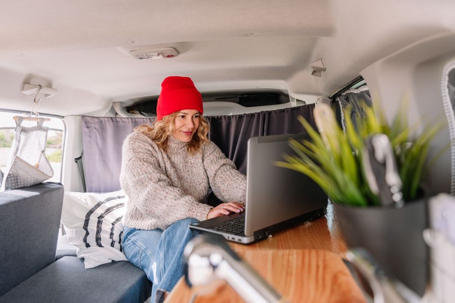 woman inside an rv on her laptop