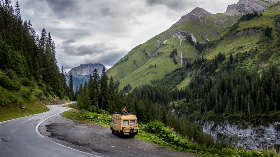 RV in the forest mountain road in the mountains