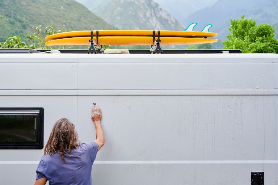 a person cleaning the outside of their rv