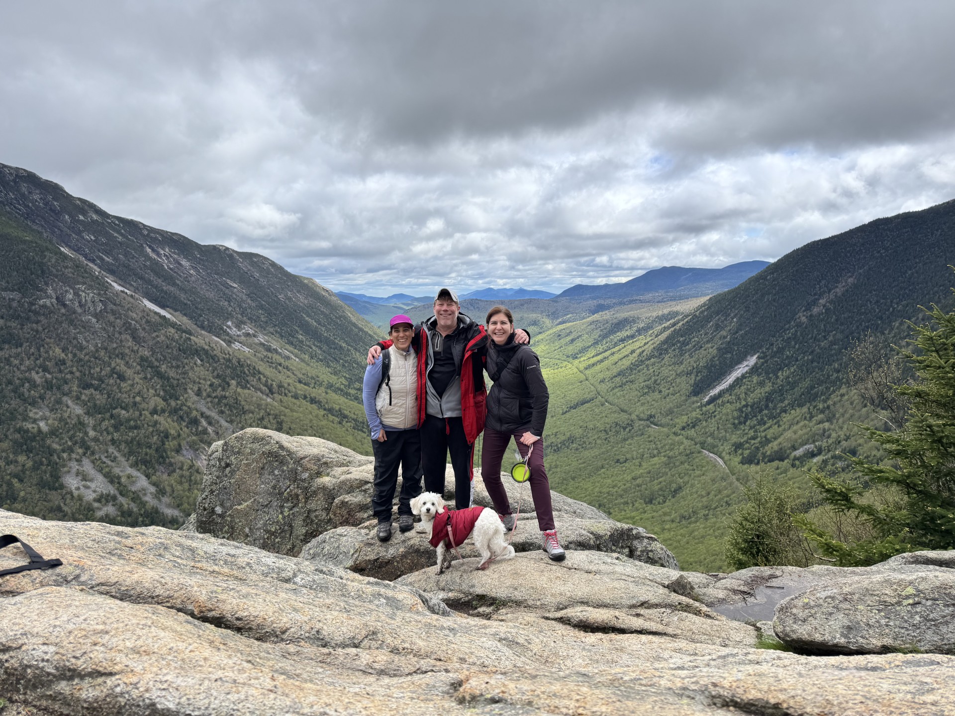 Family Travel Photo Guest blogger Melinda and her family or friends in front of a mountain view.